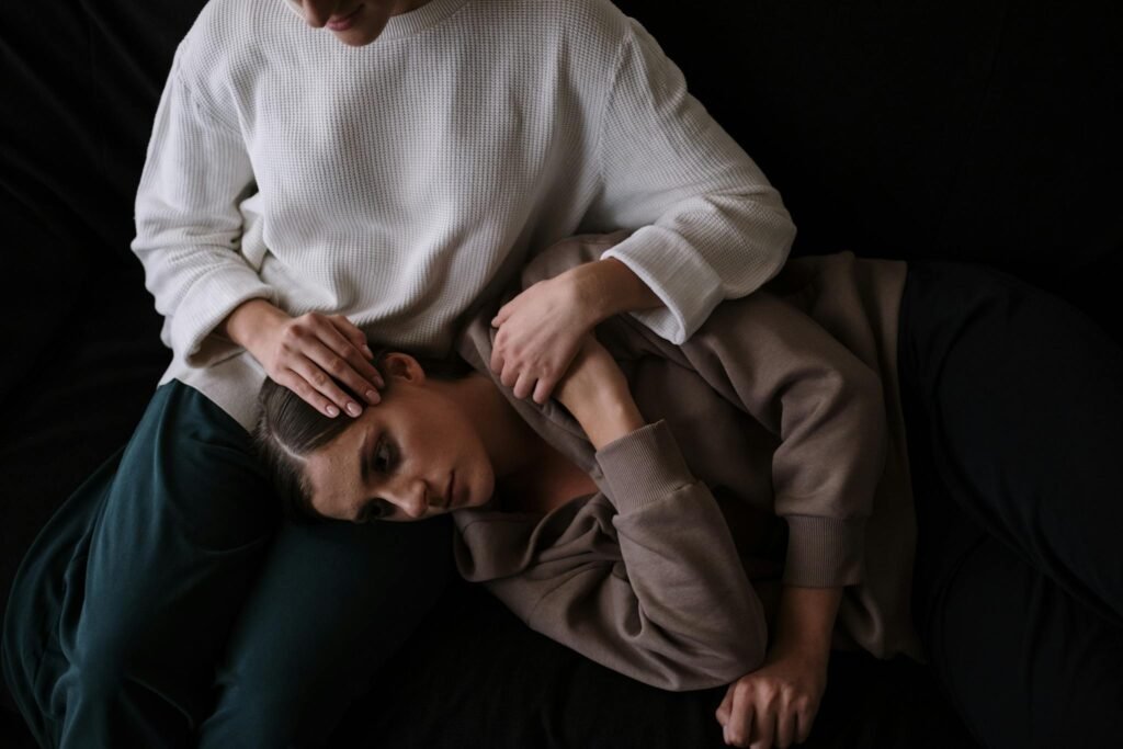 Two people share an intimate moment, symbolizing comfort and emotional support.